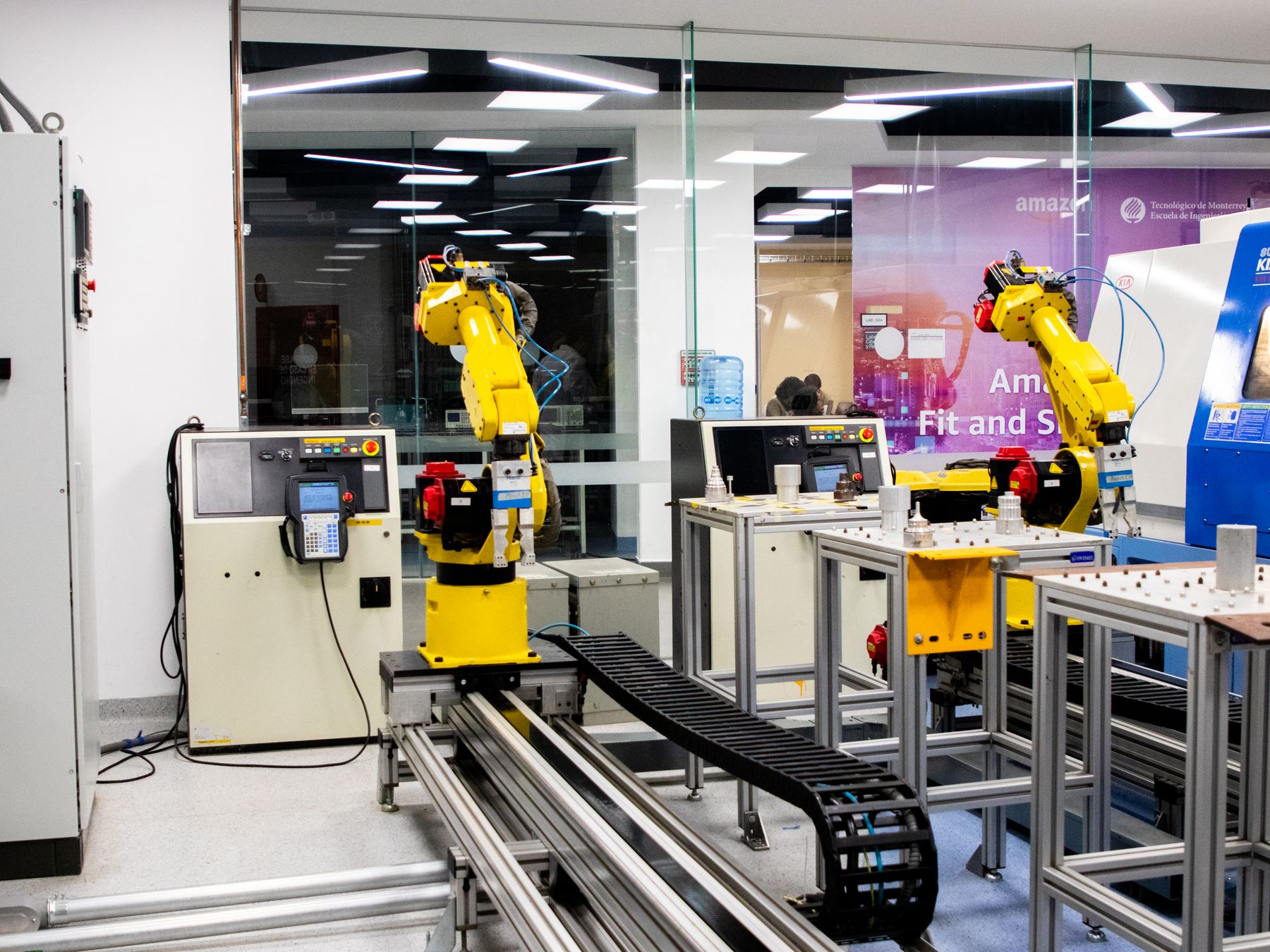 Industrial automation lab with robotic arms and control equipment